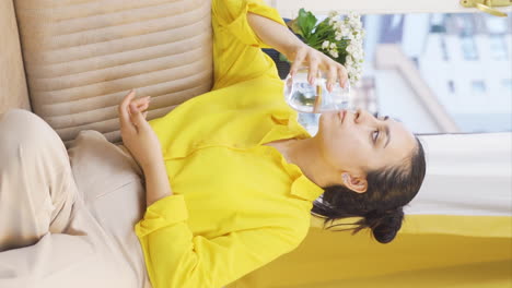 Vertical-video-of-The-young-woman-who-drinks-water.